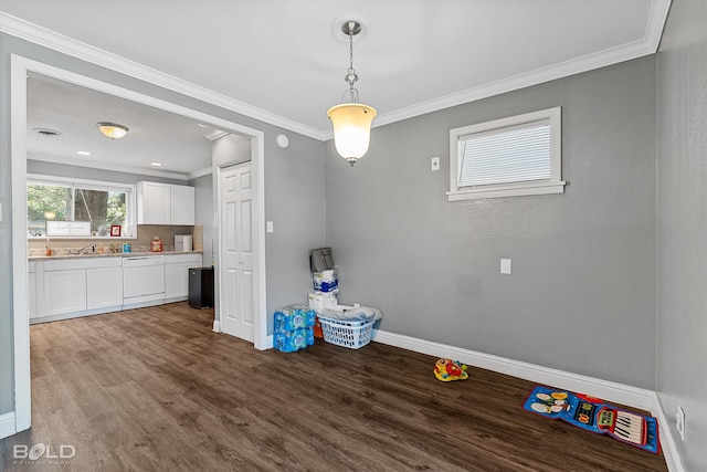 unfurnished dining area with wood-type flooring and ornamental molding