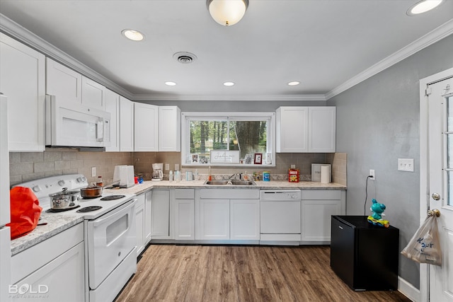 kitchen with light wood-type flooring, white appliances, white cabinetry, and sink