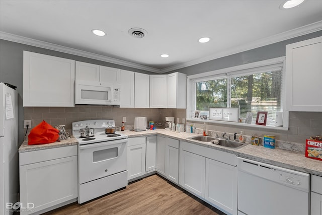 kitchen with crown molding, white appliances, white cabinetry, and sink