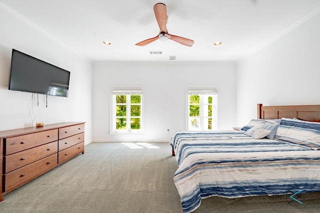 carpeted bedroom with ceiling fan, crown molding, and multiple windows