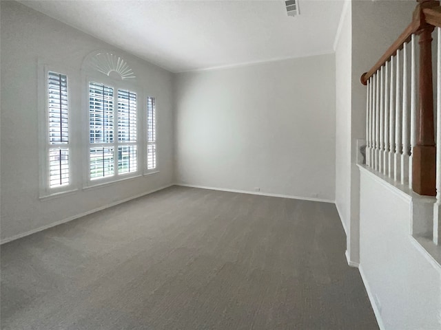 empty room featuring dark colored carpet