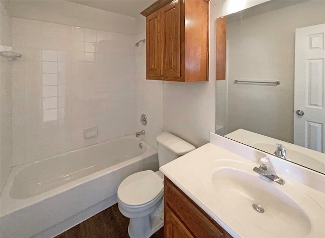 full bathroom with tiled shower / bath, vanity, and toilet