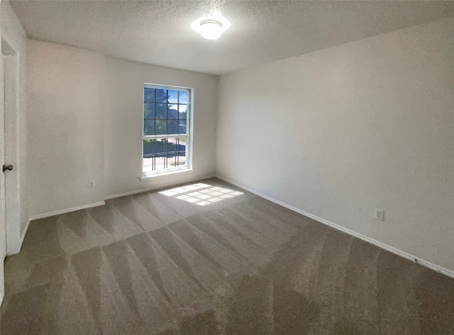 carpeted spare room featuring a textured ceiling