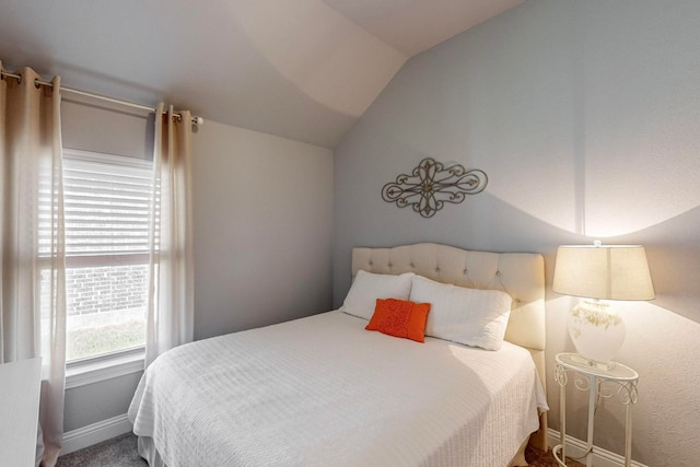 carpeted bedroom featuring vaulted ceiling