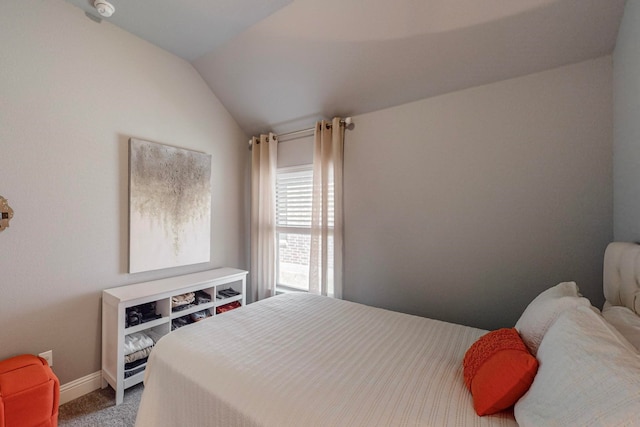 carpeted bedroom with lofted ceiling