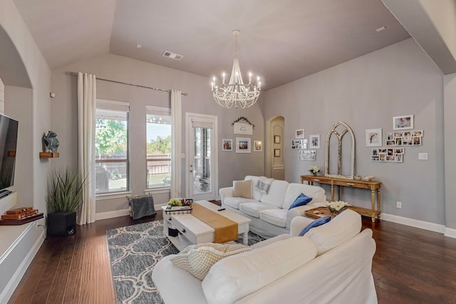 living room featuring lofted ceiling, dark hardwood / wood-style floors, and a notable chandelier