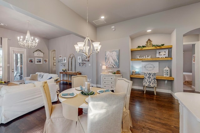 dining space featuring an inviting chandelier and dark hardwood / wood-style flooring