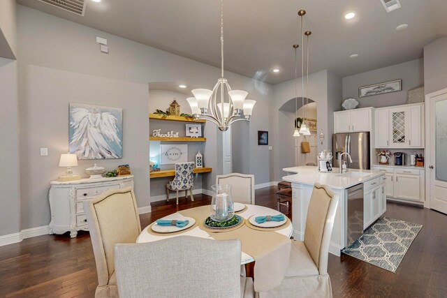 dining area featuring an inviting chandelier and dark hardwood / wood-style floors