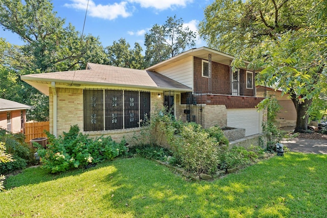 split level home with a garage and a front lawn