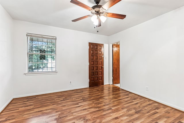 empty room featuring hardwood / wood-style floors and ceiling fan