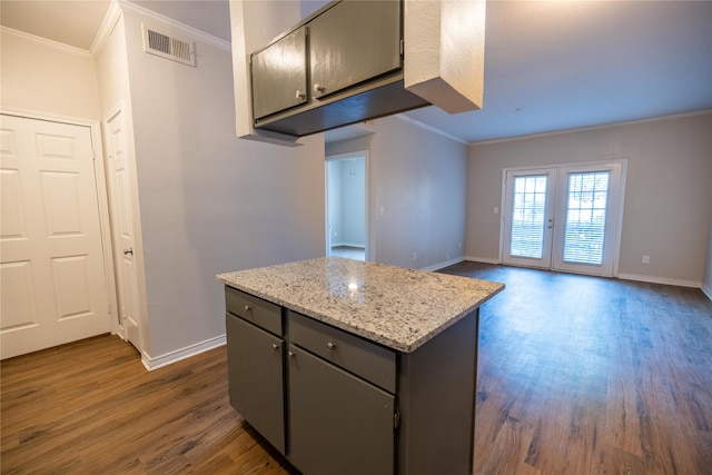 kitchen featuring french doors, ornamental molding, and dark hardwood / wood-style flooring