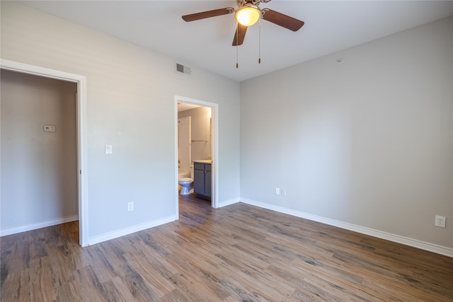 unfurnished bedroom featuring ceiling fan, hardwood / wood-style flooring, and ensuite bathroom