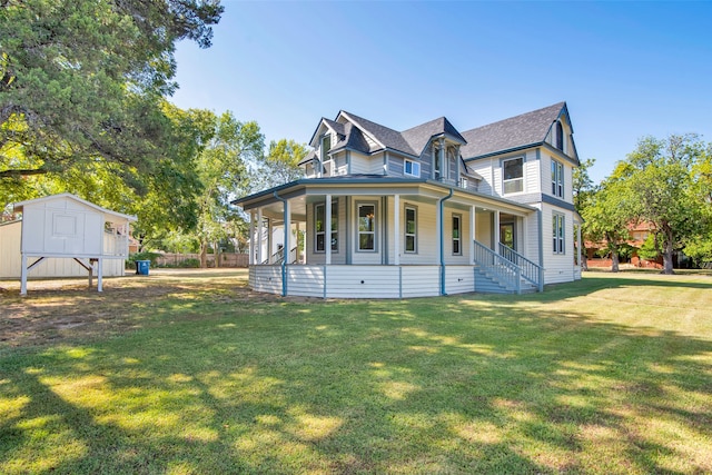 victorian house featuring a storage unit, a front lawn, and a porch