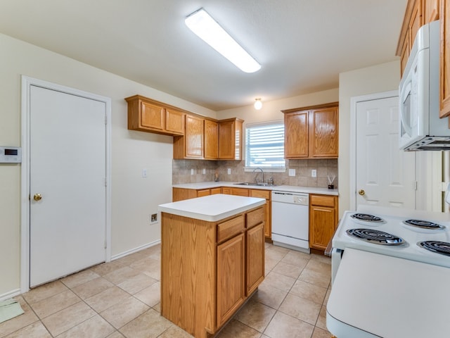 kitchen with light tile patterned floors, tasteful backsplash, sink, white appliances, and a center island