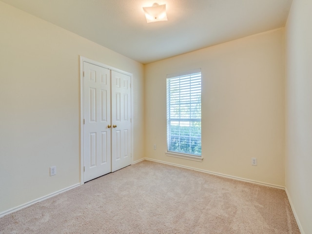 empty room featuring light carpet