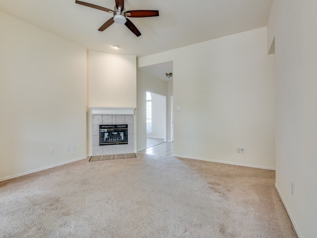 unfurnished living room featuring a fireplace, ceiling fan, and light carpet