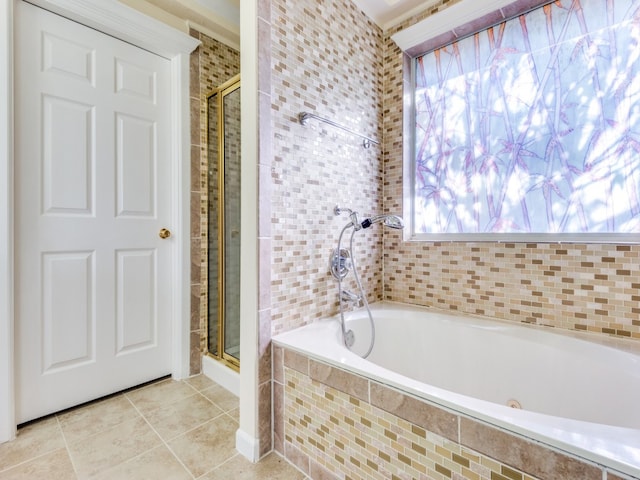 bathroom featuring separate shower and tub, tile patterned floors, and a wealth of natural light