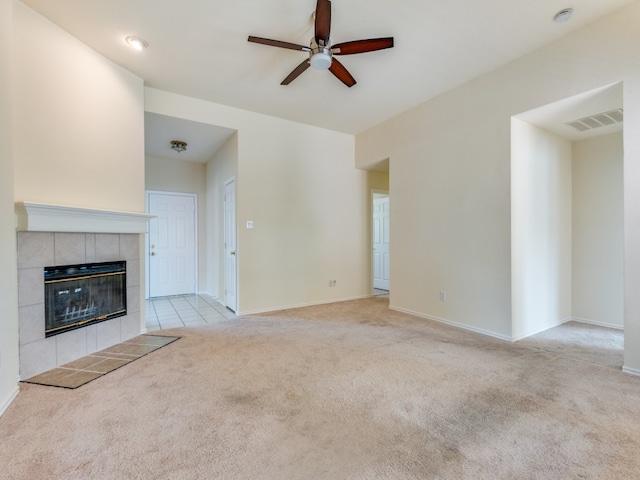 unfurnished living room with light carpet, a fireplace, and ceiling fan