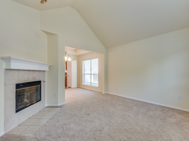 unfurnished living room with high vaulted ceiling, light colored carpet, and a fireplace