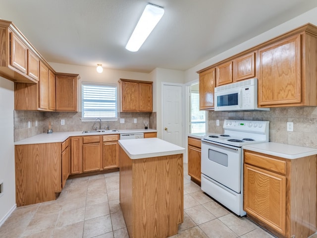 kitchen featuring white appliances, light tile patterned floors, a center island, and tasteful backsplash