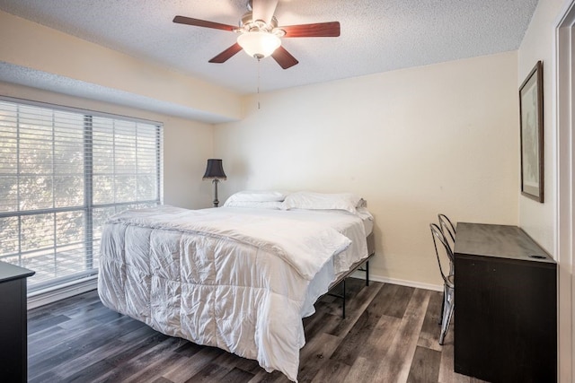 bedroom featuring a textured ceiling, ceiling fan, and dark wood-type flooring