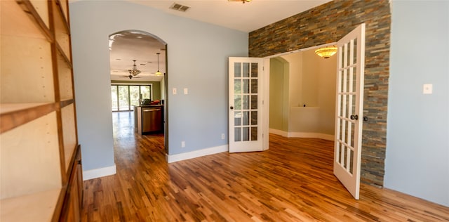 spare room featuring french doors, hardwood / wood-style floors, and ceiling fan