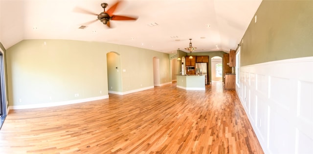 unfurnished living room with ceiling fan, lofted ceiling, and light hardwood / wood-style floors