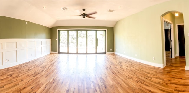 spare room featuring lofted ceiling, ceiling fan, and light wood-type flooring