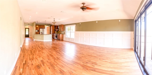 unfurnished living room featuring ceiling fan and light hardwood / wood-style floors