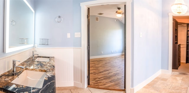 bathroom with vanity, hardwood / wood-style flooring, and ceiling fan with notable chandelier