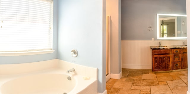 bathroom featuring vanity and a bath