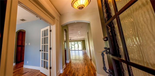 hallway with hardwood / wood-style floors