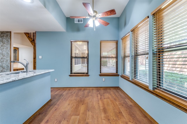 interior space featuring ceiling fan, sink, and hardwood / wood-style flooring