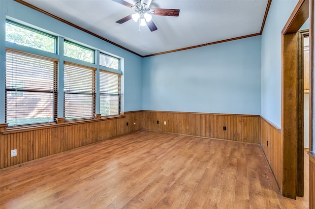 empty room with light hardwood / wood-style floors, ceiling fan, and crown molding