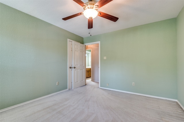 unfurnished room featuring ceiling fan and light carpet