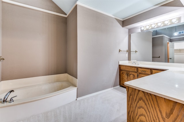 bathroom featuring vanity, vaulted ceiling, a bathtub, and ornamental molding