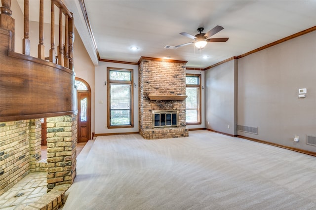 unfurnished living room with a fireplace, light carpet, ceiling fan, and crown molding