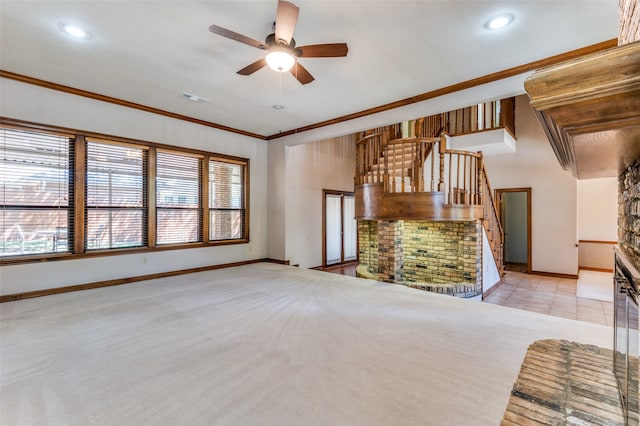 unfurnished living room featuring ceiling fan, ornamental molding, and light carpet