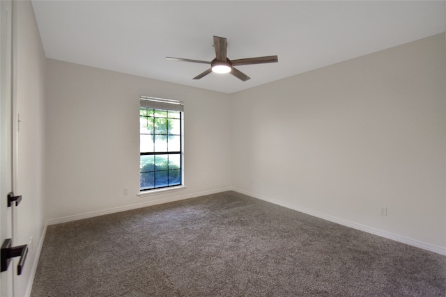 unfurnished room with dark carpet and ceiling fan