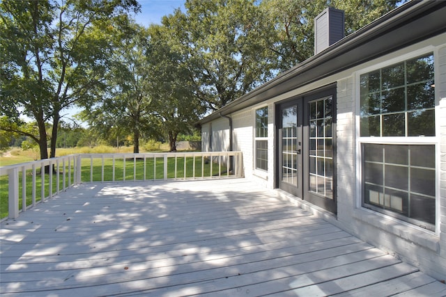 deck featuring a yard and french doors