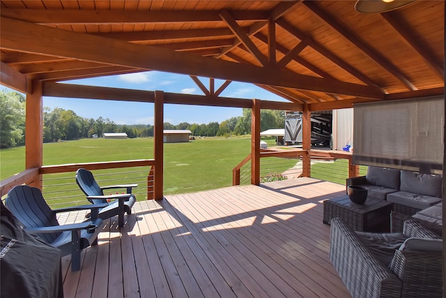 wooden terrace with outdoor lounge area, a gazebo, and a yard