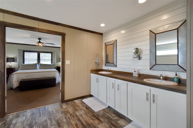 bathroom featuring hardwood / wood-style floors, ceiling fan, vanity, and crown molding