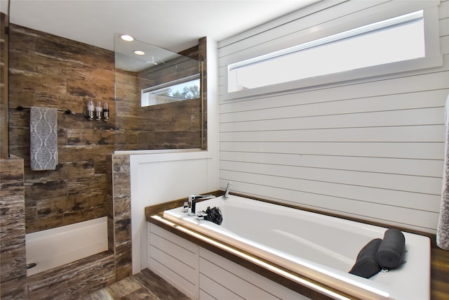 bathroom with plus walk in shower and hardwood / wood-style floors