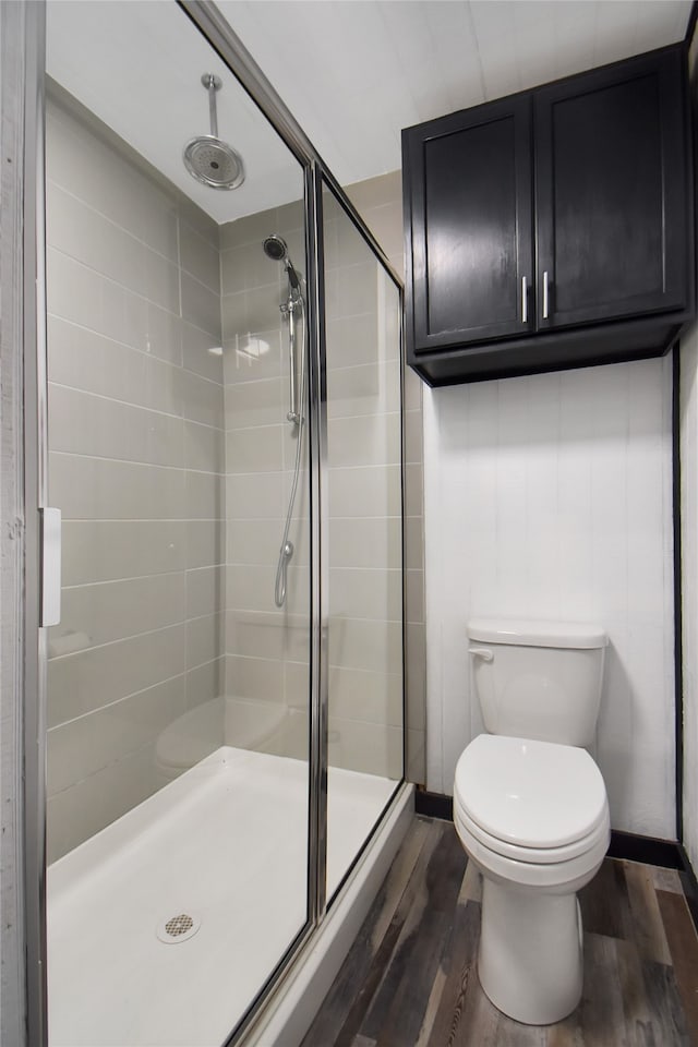 bathroom with walk in shower, hardwood / wood-style floors, and toilet