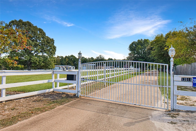 view of gate with a yard