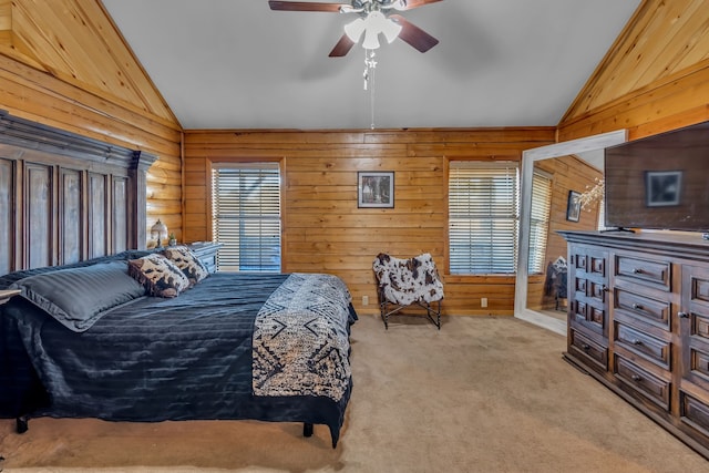 carpeted bedroom with wood walls, vaulted ceiling, and ceiling fan