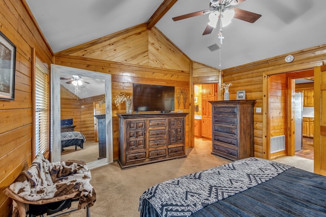 carpeted bedroom with beam ceiling, stainless steel fridge, wooden walls, and ceiling fan