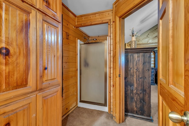 bathroom with wooden walls and walk in shower