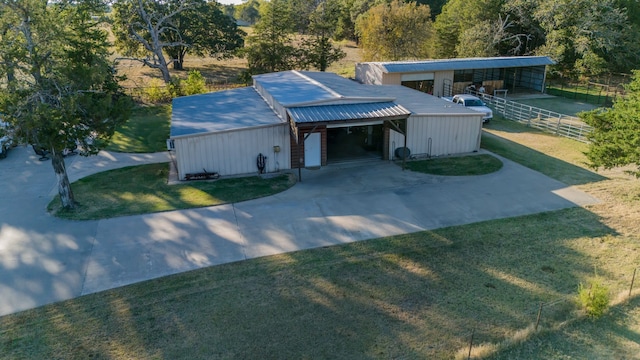 view of front of property with metal roof, fence, driveway, a carport, and a front lawn