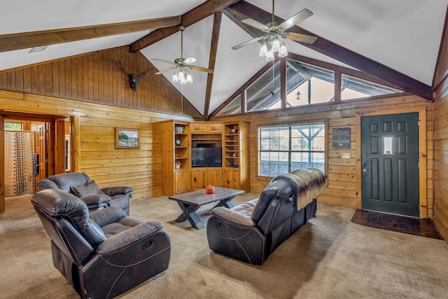 living room featuring beam ceiling, wooden walls, carpet, high vaulted ceiling, and ceiling fan